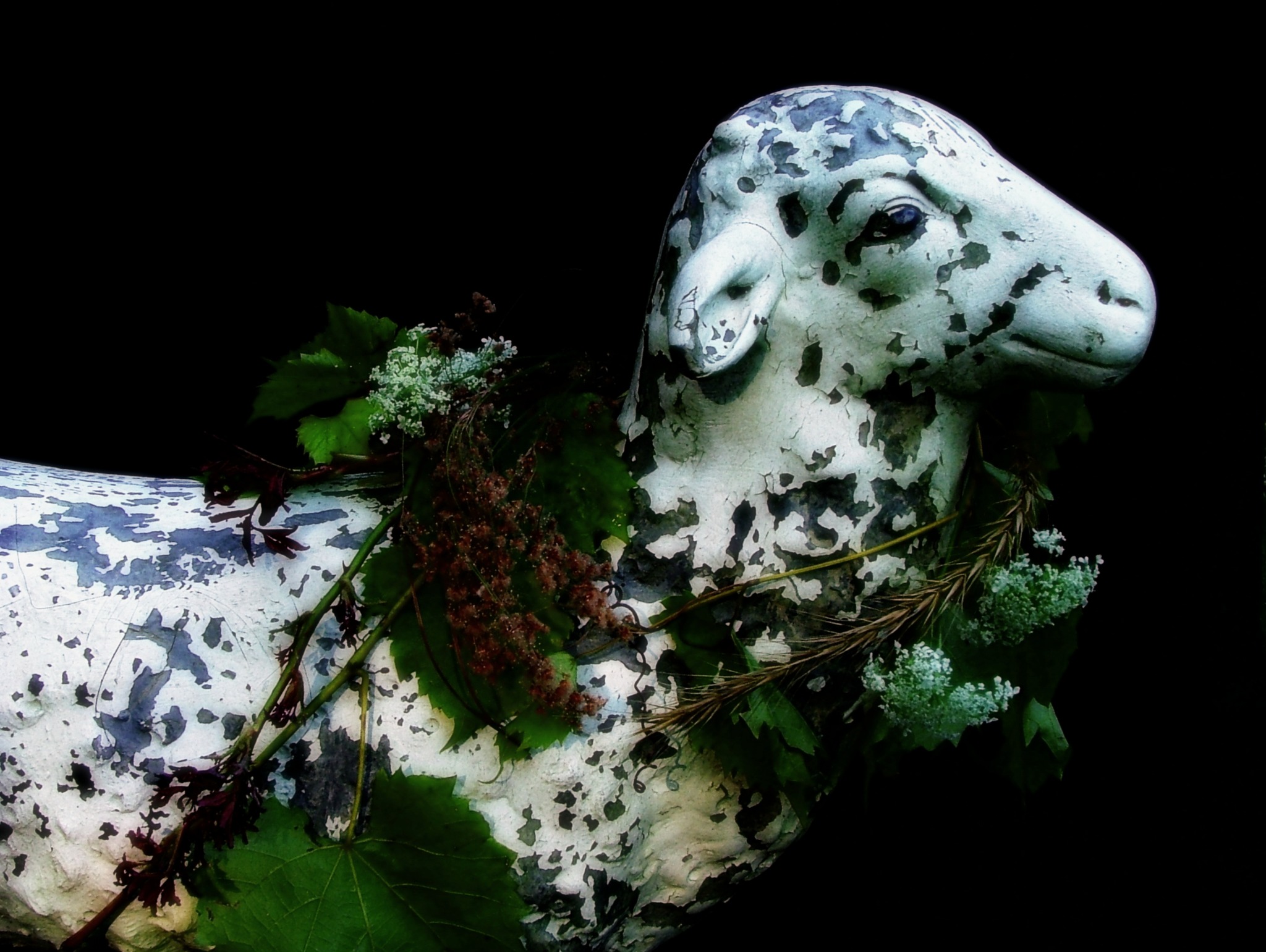 Pale sculptural form among moss and leaves